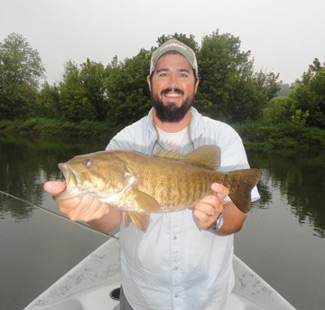 Josh Pfeiffer with a large smallmouth caught on a tailwater.